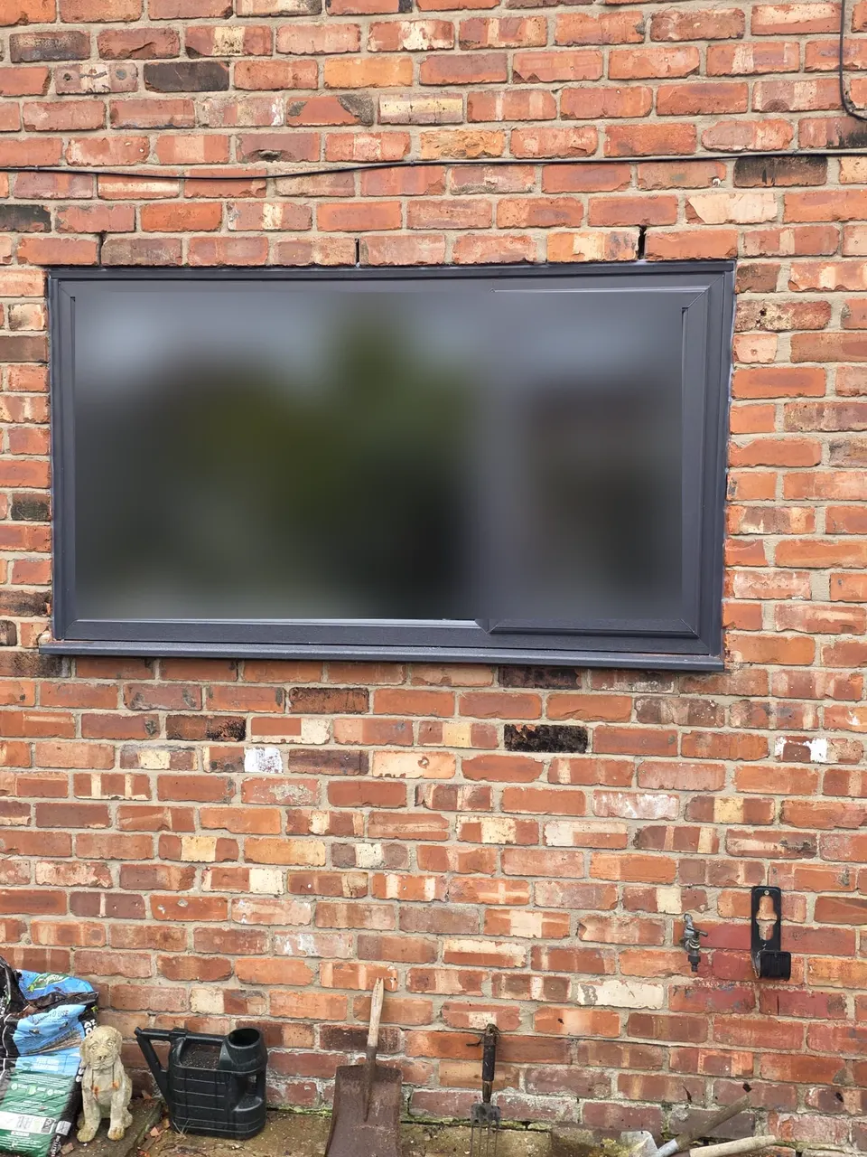 After: anthracite grey uPVC window fitted on a brick house in Alwoodley